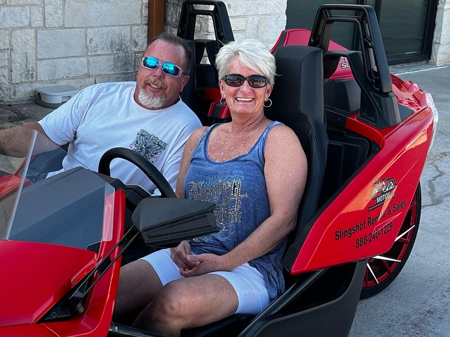 a man and a woman sitting on a motorcycle